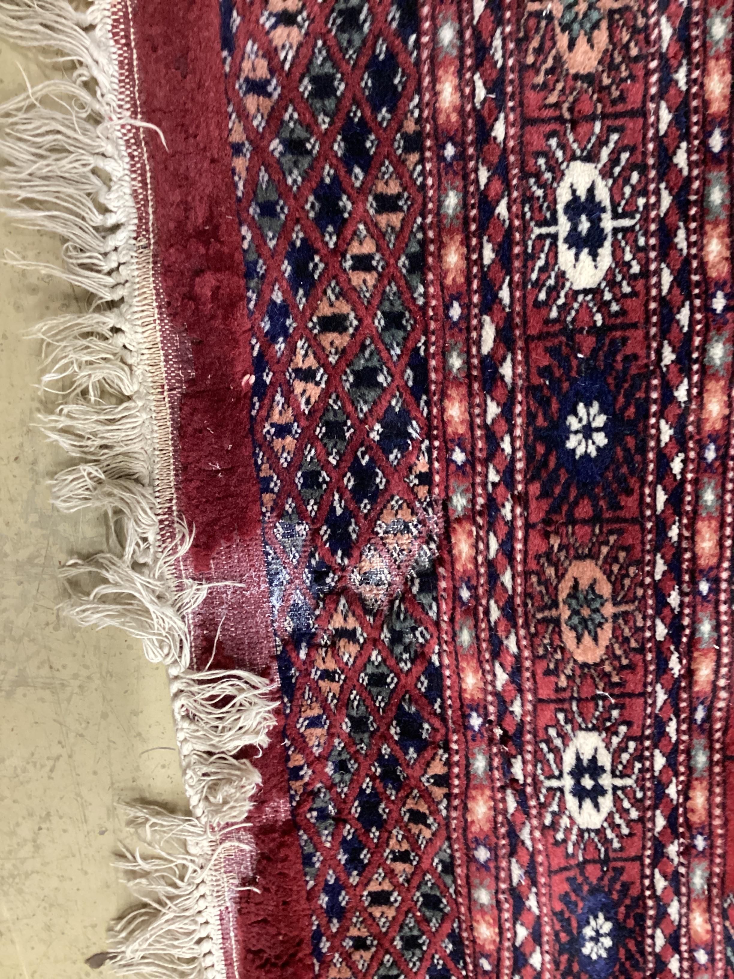 A Bokhara red ground rug, 150 x 96cm